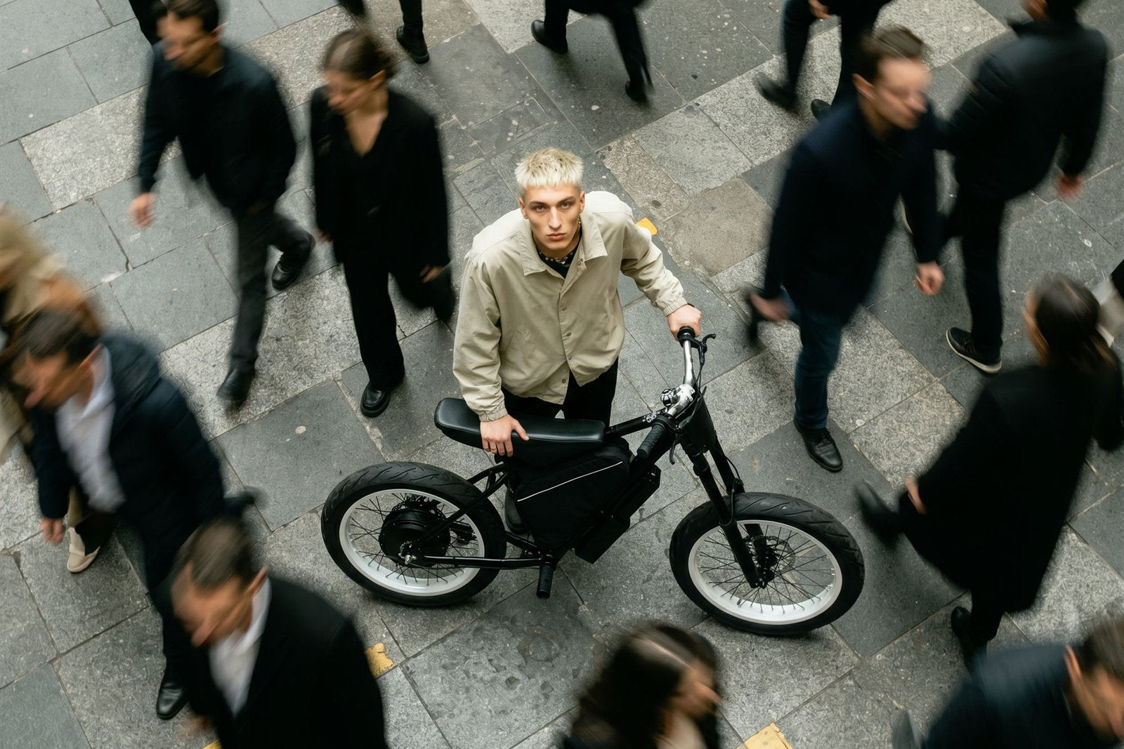 Rider with an F1 e-bike amid a city crowd