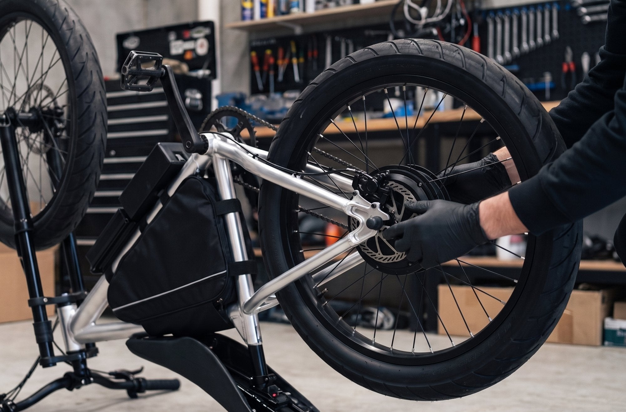 Installing an F1 hub-motor wheel onto an e-bike frame in the workshop